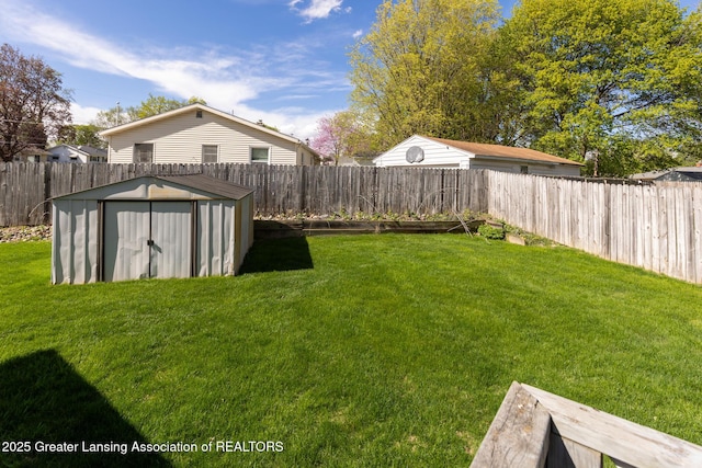 view of yard with a fenced backyard, an outdoor structure, and a shed