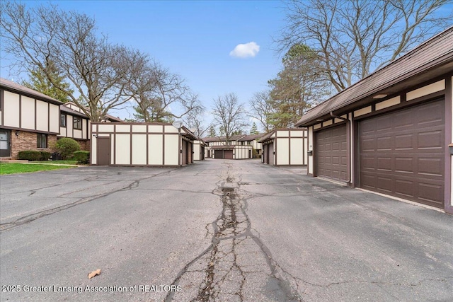 view of road featuring community garages