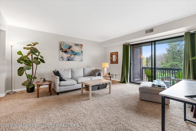 living room with baseboards, light colored carpet, and visible vents