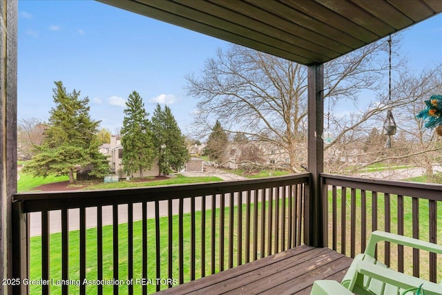 wooden terrace featuring a lawn