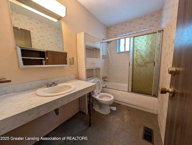3536 Maybel St, Lansing, MI 48911 - bathroom with bath / shower combo with glass door, toilet, wallpapered walls, vanity, and tile patterned flooring