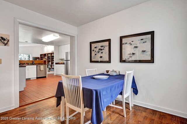 dining room featuring baseboards and wood finished floors