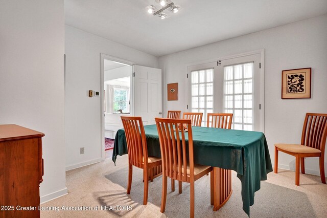 dining room featuring baseboards and carpet