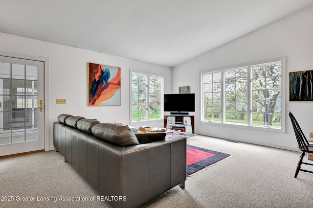 living room with baseboards, light colored carpet, and vaulted ceiling
