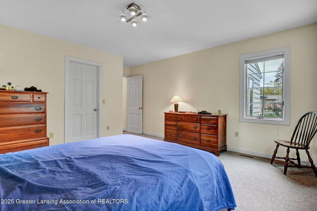 bedroom featuring carpet flooring, baseboards, and visible vents