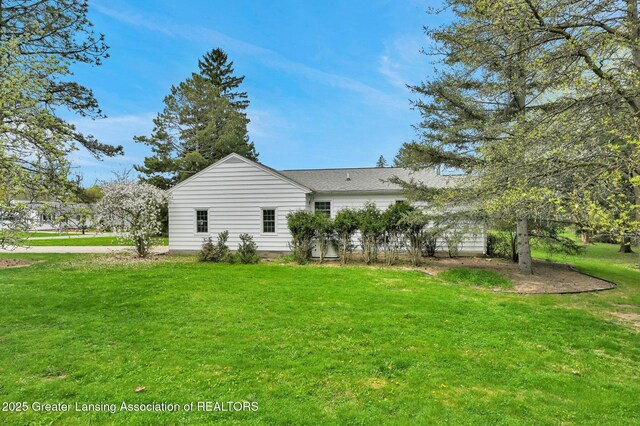 rear view of house with a lawn