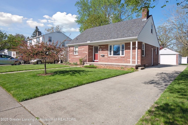 view of front of home with roof with shingles, brick siding, a garage, a front yard, and an outdoor structure
