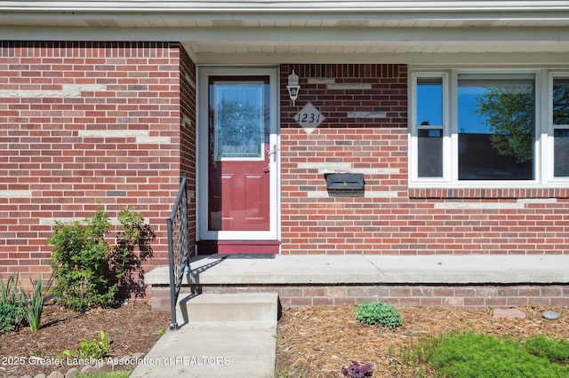 doorway to property with brick siding