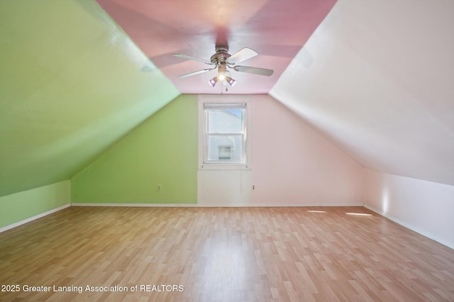 bonus room featuring baseboards, a ceiling fan, wood finished floors, and vaulted ceiling