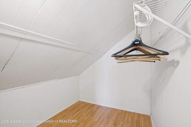 spacious closet featuring light wood-style floors and lofted ceiling