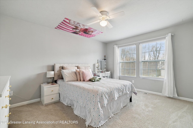 bedroom with baseboards, ceiling fan, visible vents, and light carpet