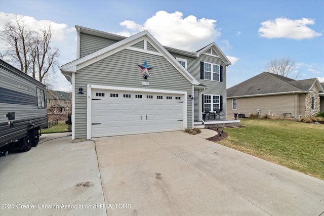 traditional home featuring fence, a garage, driveway, and a front lawn