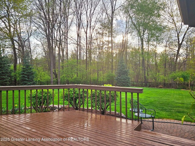 deck with a fenced backyard and a yard