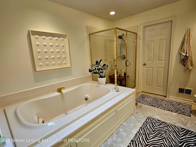bathroom featuring visible vents, a jetted tub, and a stall shower