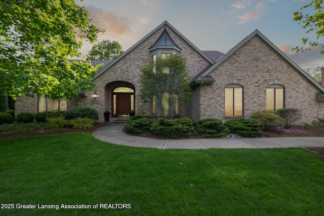 3641 Beech Tree Ln, Okemos, MI 48864 - french country home with a front lawn and brick siding