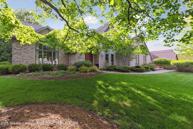3641 Beech Tree Ln, Okemos, MI 48864 - view of property hidden behind natural elements with a front lawn and brick siding