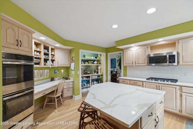 3641 Beech Tree Ln, Okemos, MI 48864 - kitchen with open shelves, appliances with stainless steel finishes, a kitchen island, light brown cabinets, and recessed lighting