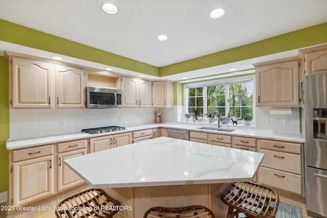 3641 Beech Tree Ln, Okemos, MI 48864 - kitchen with light brown cabinets, appliances with stainless steel finishes, a sink, recessed lighting, and light stone counters
