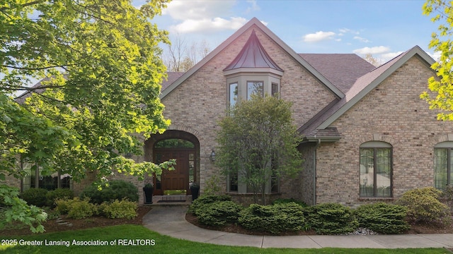3641 Beech Tree Ln, Okemos, MI 48864 - tudor-style house featuring brick siding and a shingled roof