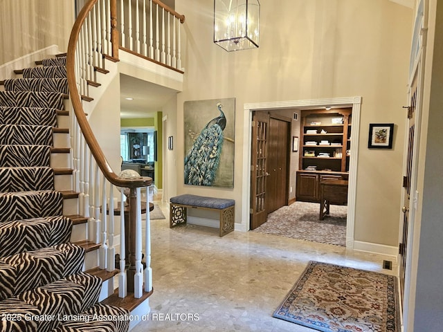 3641 Beech Tree Ln, Okemos, MI 48864 - foyer with stairs, a towering ceiling, baseboards, and a chandelier
