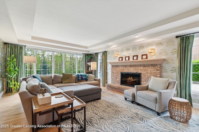 3641 Beech Tree Ln, Okemos, MI 48864 - living area with light wood finished floors, a raised ceiling, a brick fireplace, and wallpapered walls