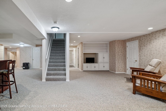 3641 Beech Tree Ln, Okemos, MI 48864 - living area with wallpapered walls, carpet, and stairs