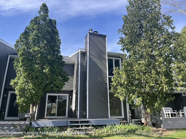 1425 E Lakeside Dr, East Lansing, MI 48823 - back of property with a wooden deck and a chimney