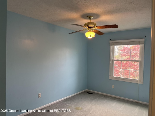 1425 E Lakeside Dr, East Lansing, MI 48823 - unfurnished room featuring visible vents, baseboards, ceiling fan, a textured ceiling, and carpet