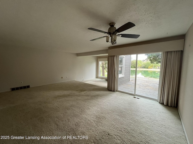 1425 E Lakeside Dr, East Lansing, MI 48823 - spare room with ceiling fan, carpet flooring, a textured ceiling, and visible vents