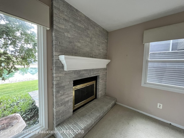 1425 E Lakeside Dr, East Lansing, MI 48823 - interior details featuring baseboards, carpet flooring, and a fireplace