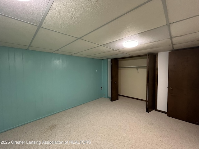 1425 E Lakeside Dr, East Lansing, MI 48823 - unfurnished bedroom with a closet, light colored carpet, and a paneled ceiling