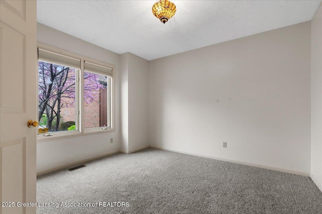 2454 Emerald Lake Dr, East Lansing, MI 48823 - carpeted empty room with a textured ceiling, baseboards, and visible vents