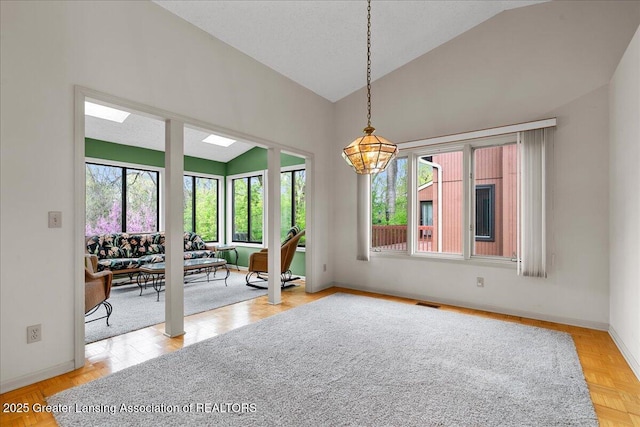 2454 Emerald Lake Dr, East Lansing, MI 48823 - dining area with baseboards, visible vents, and high vaulted ceiling