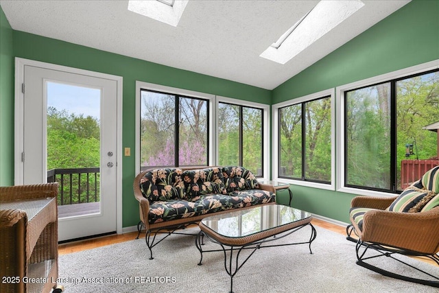 2454 Emerald Lake Dr, East Lansing, MI 48823 - living area with plenty of natural light, lofted ceiling with skylight, and wood finished floors