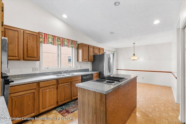 2454 Emerald Lake Dr, East Lansing, MI 48823 - kitchen featuring appliances with stainless steel finishes, a center island, brown cabinets, a sink, and lofted ceiling