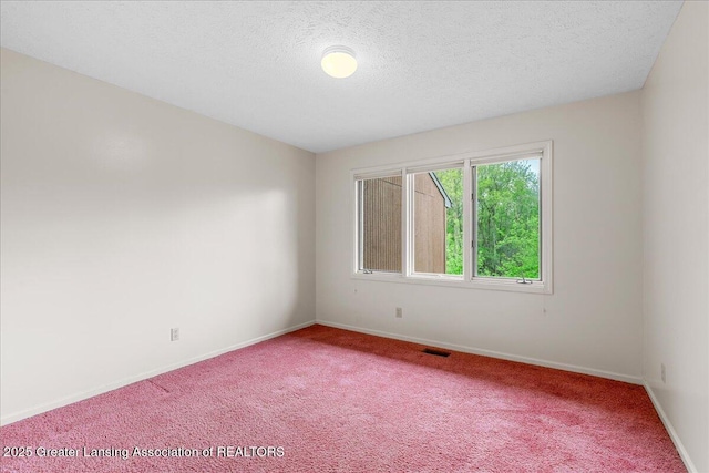 2454 Emerald Lake Dr, East Lansing, MI 48823 - empty room with visible vents, a textured ceiling, baseboards, and light carpet