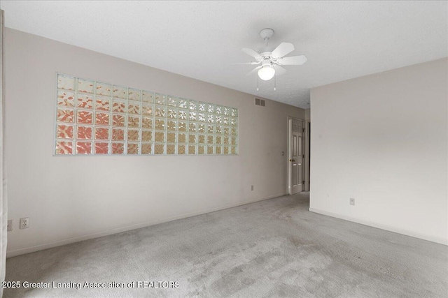 2454 Emerald Lake Dr, East Lansing, MI 48823 - carpeted empty room featuring baseboards, a ceiling fan, and visible vents