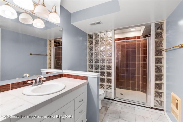 2454 Emerald Lake Dr, East Lansing, MI 48823 - full bathroom featuring vanity, toilet, marble finish floor, visible vents, and a stall shower