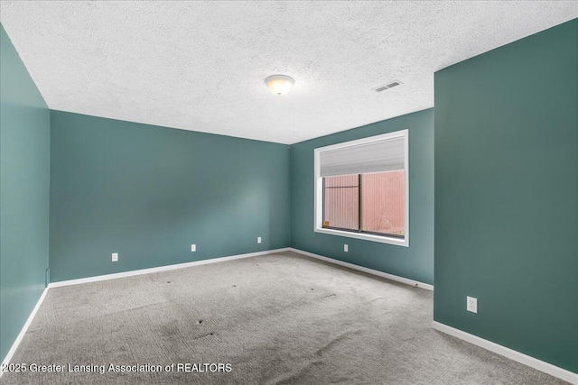 2454 Emerald Lake Dr, East Lansing, MI 48823 - empty room with baseboards, carpet, a textured ceiling, and visible vents