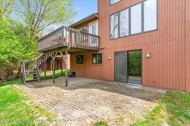 2454 Emerald Lake Dr, East Lansing, MI 48823 - back of house featuring stairs, a patio area, and a deck