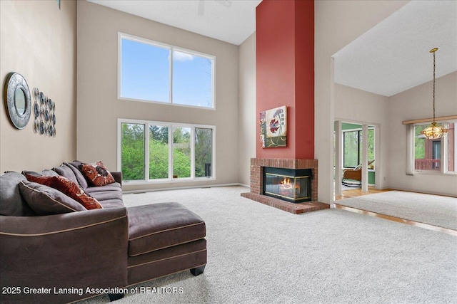 2454 Emerald Lake Dr, East Lansing, MI 48823 - living room featuring high vaulted ceiling, plenty of natural light, a fireplace, and carpet floors