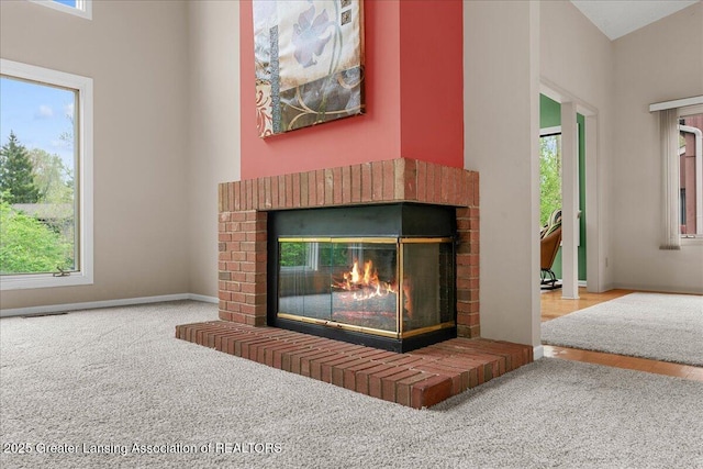 2454 Emerald Lake Dr, East Lansing, MI 48823 - room details with baseboards, carpet flooring, a brick fireplace, and visible vents