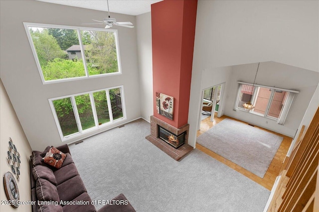 2454 Emerald Lake Dr, East Lansing, MI 48823 - living area featuring a high ceiling, ceiling fan, and visible vents