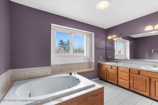 2454 Emerald Lake Dr, East Lansing, MI 48823 - bathroom featuring double vanity, tile patterned floors, a sink, and a bath