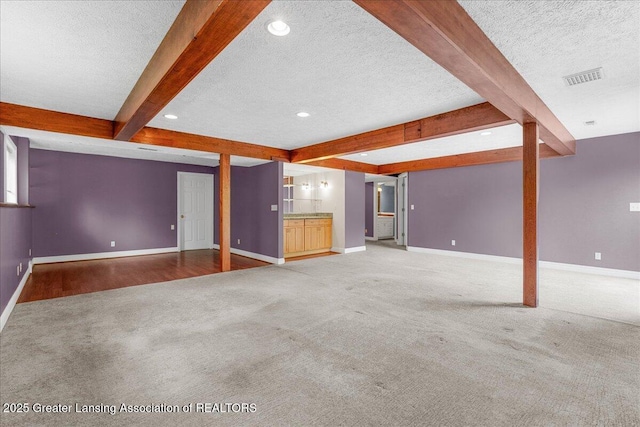 2454 Emerald Lake Dr, East Lansing, MI 48823 - unfurnished living room featuring carpet floors, baseboards, visible vents, and beam ceiling