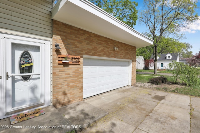 garage with concrete driveway