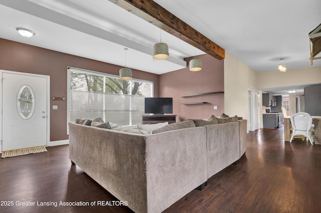 living room with baseboards, dark wood-style flooring, and beam ceiling