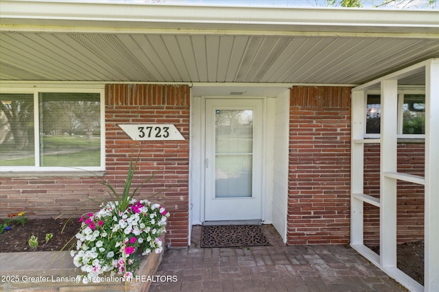 entrance to property with brick siding
