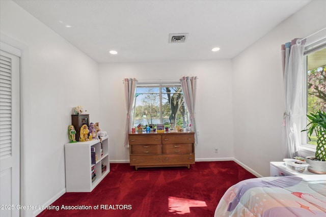 bedroom with carpet floors, multiple windows, baseboards, and visible vents