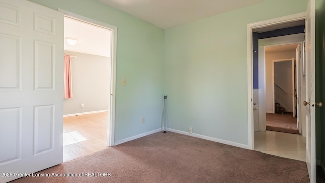 unfurnished bedroom with baseboards and carpet